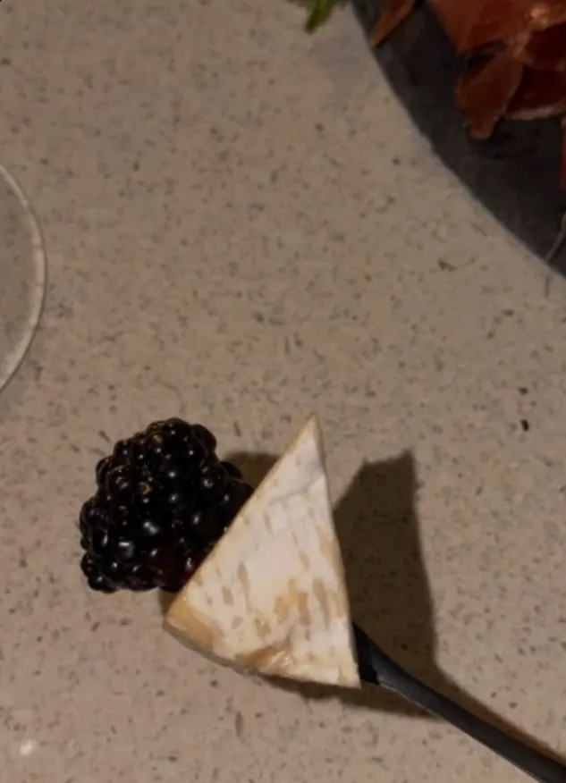 Brie con mora en un tenedor